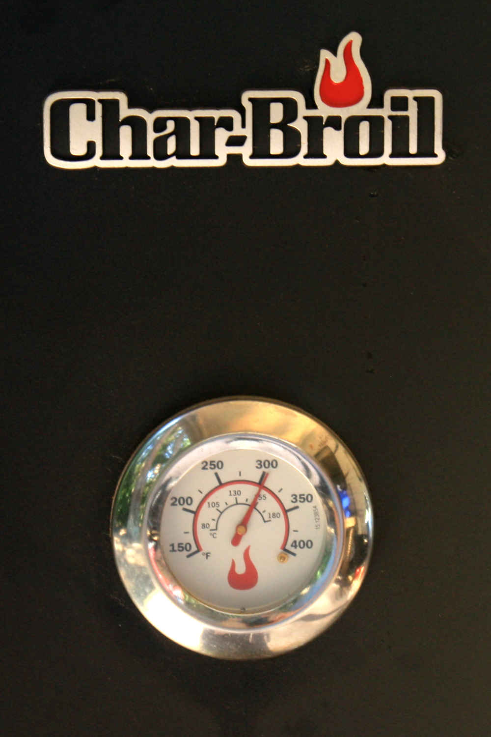 The temperature gauge of my Char Broil propane smoker, showing that it's heated up to 300 degrees Fahrenheit, great for quick-smoking chicken.