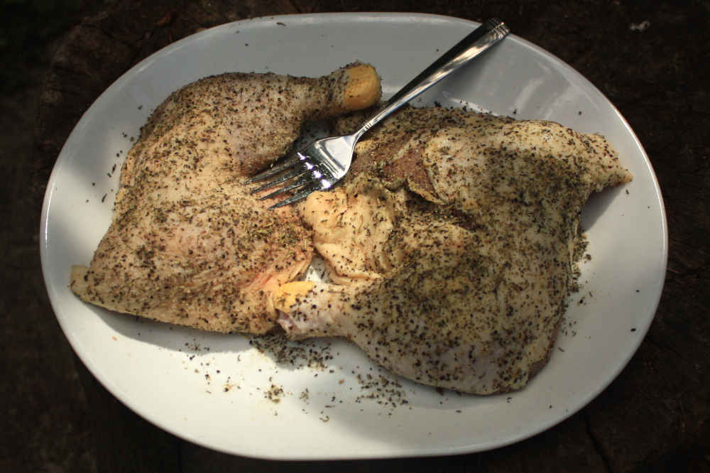 Chicken leg quarters after being treated with baking powder as a skin tenderizer.